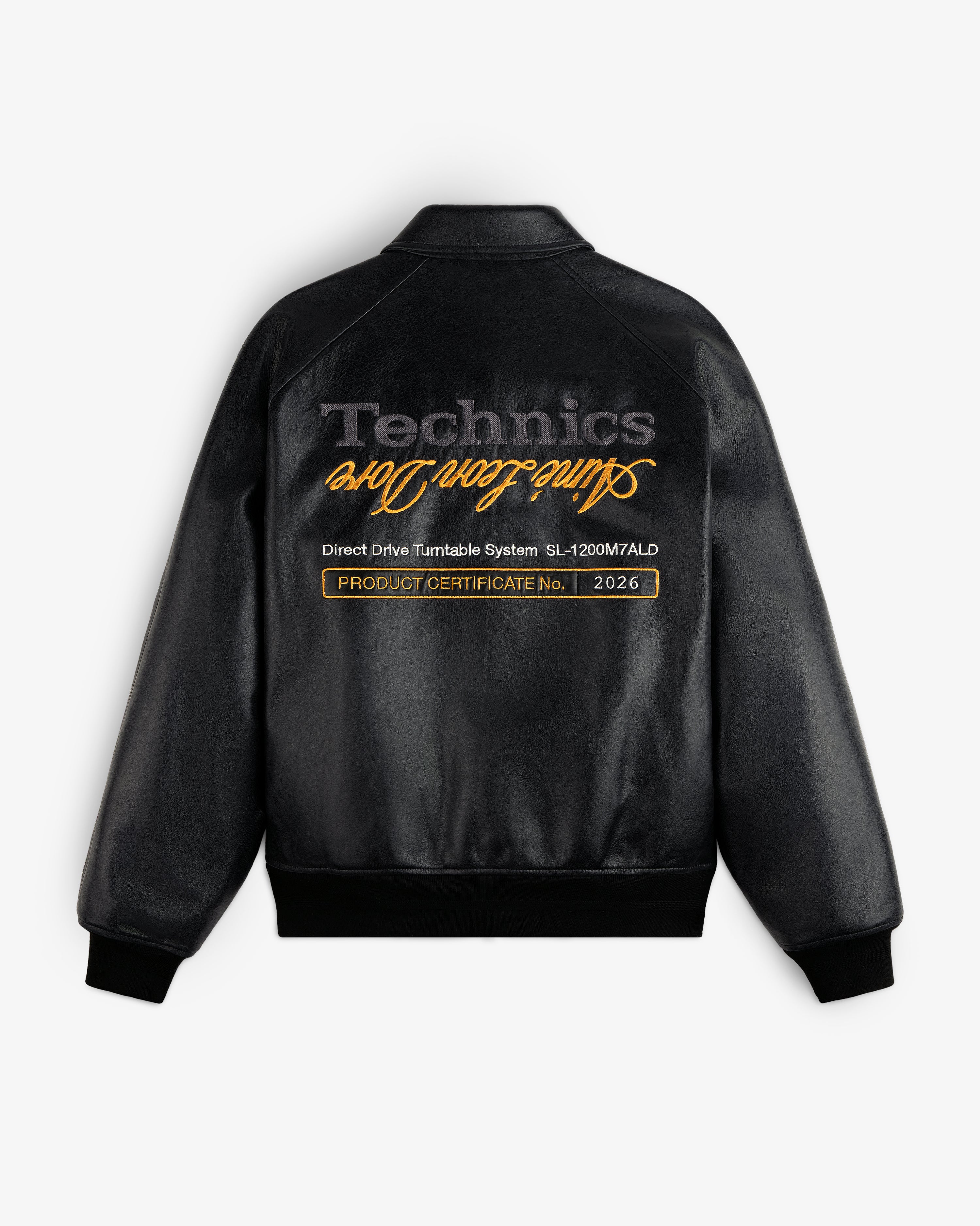 ALD / Technics Varsity Leather Jacket: black leather, gold cursive text on back, with product certificate label.