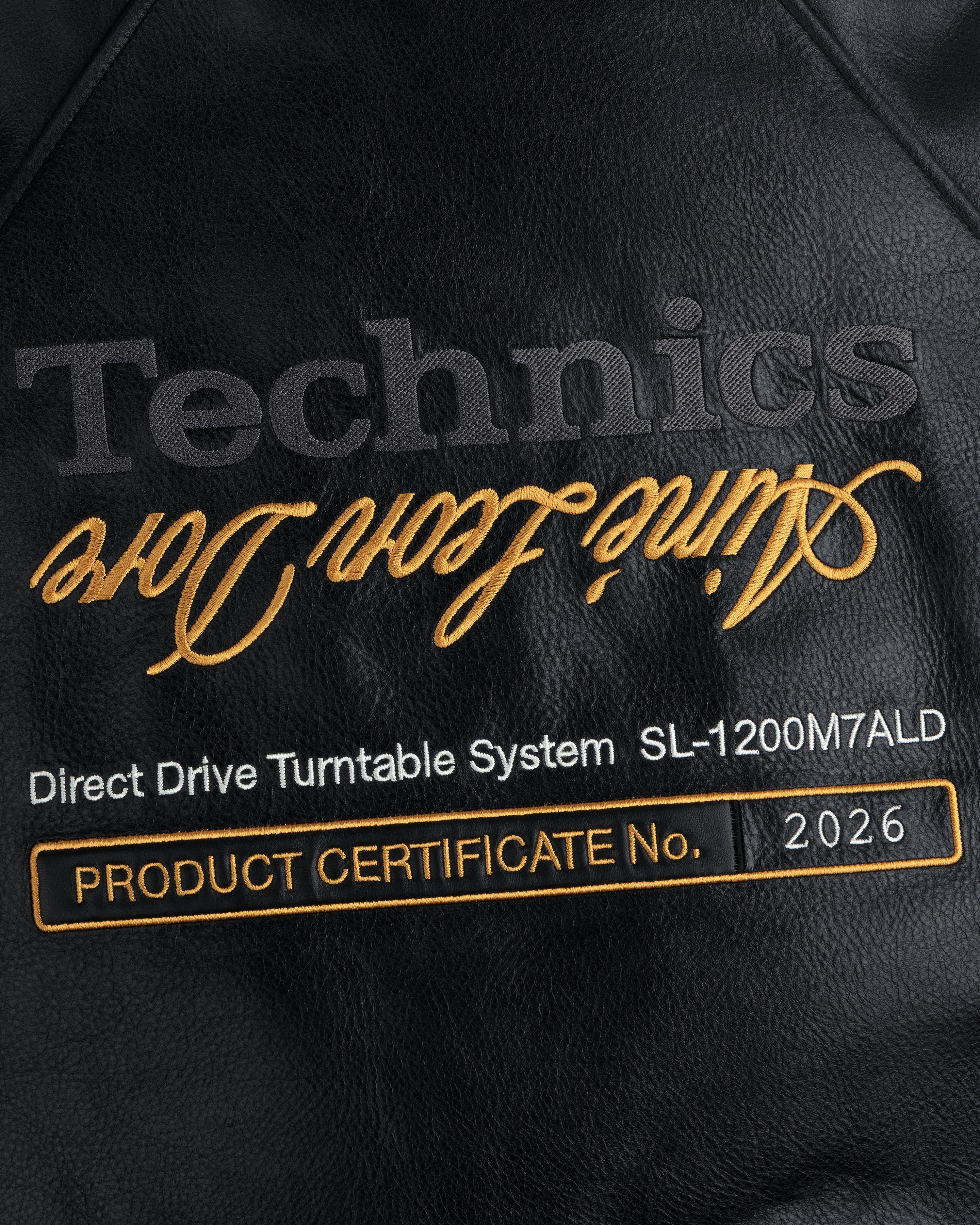 Black leather patch on ALD / Technics Varsity Jacket: Technics, Direct Drive Turntable System, CERTIFICATE No. 2026.