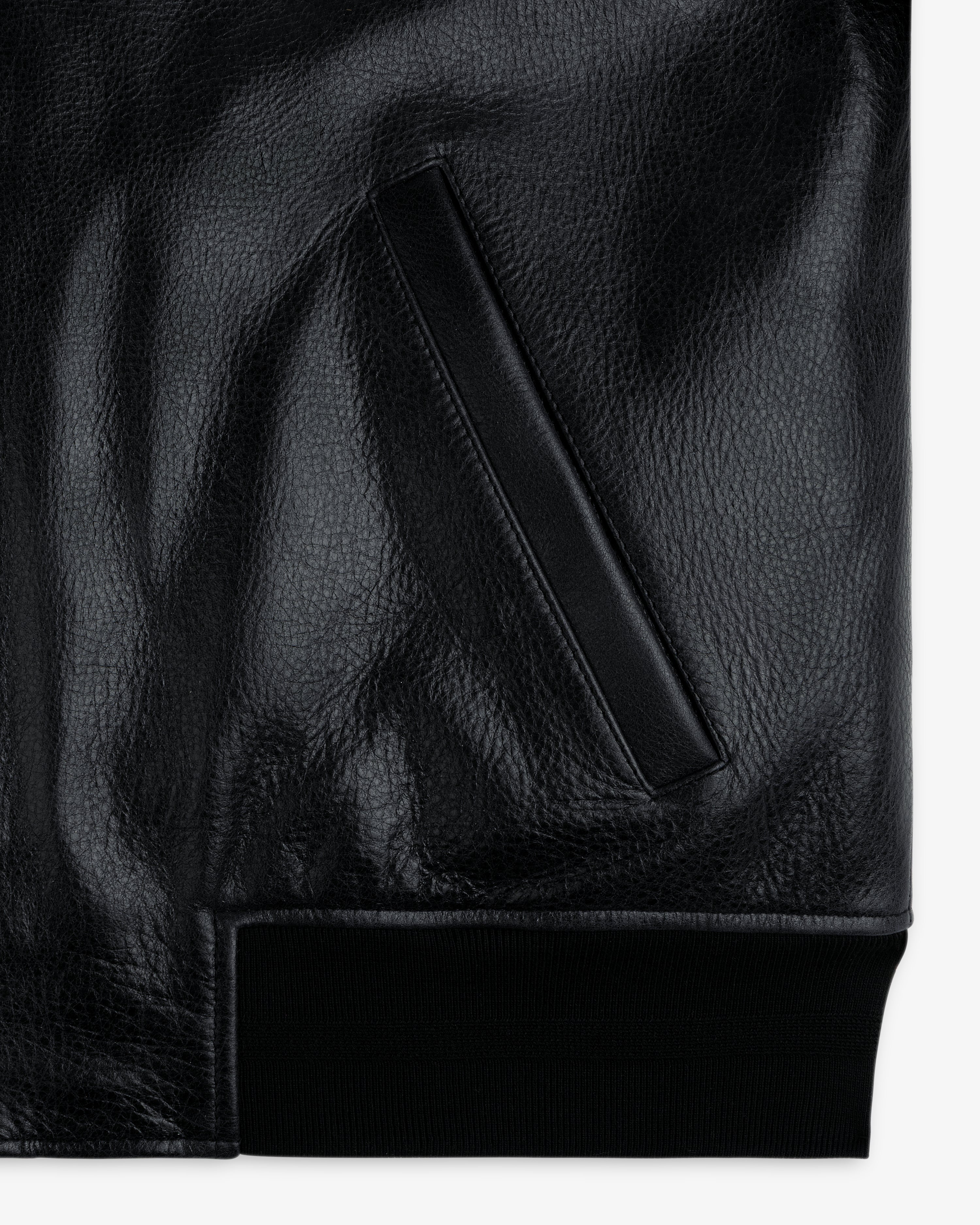 Close-up of the ALD / Technics Varsity Leather Jacket pocket featuring a ribbed knit hem at the bottom.