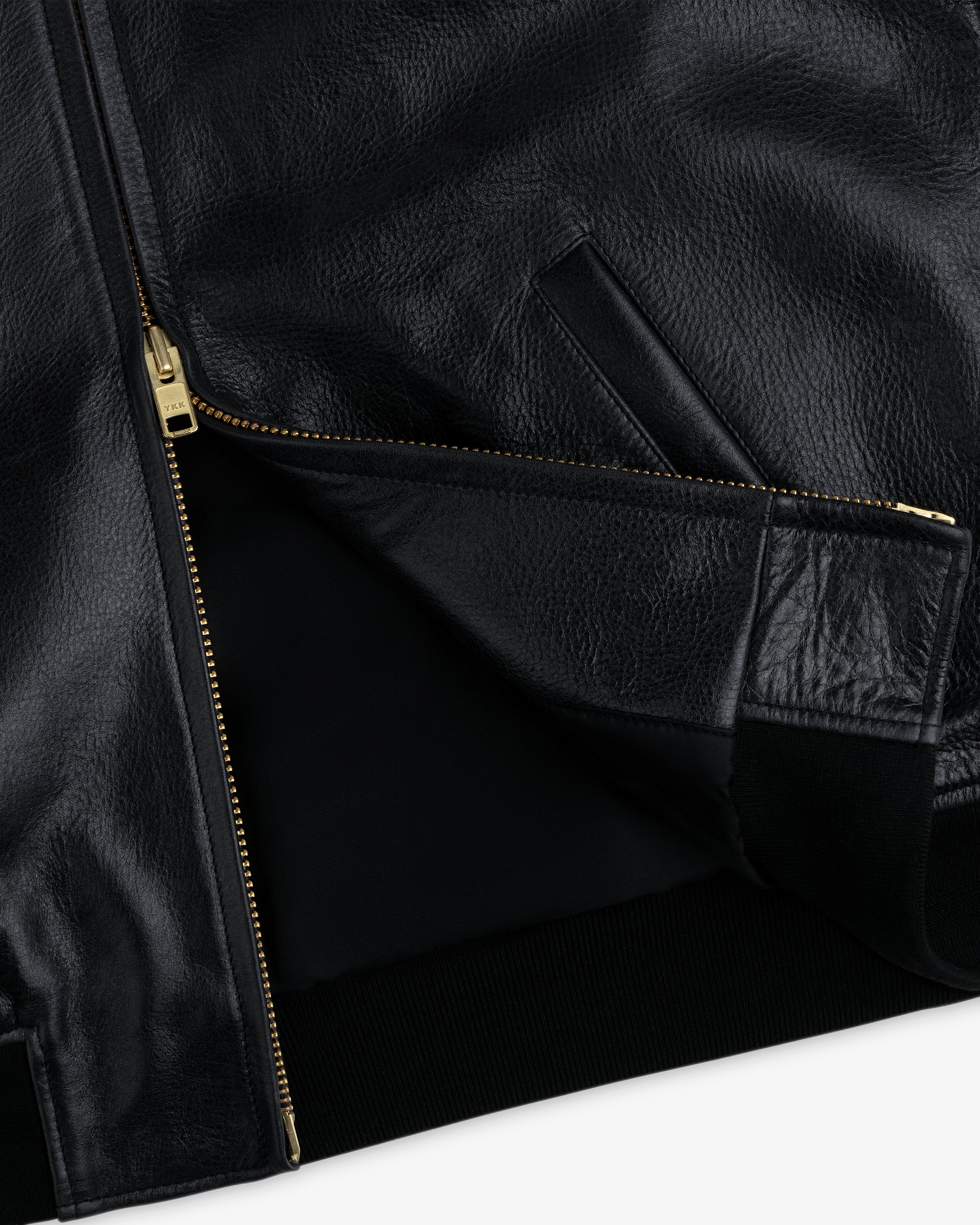 ALD / Technics Varsity Leather Jacket in black leather with gold zippers and a partially open front.