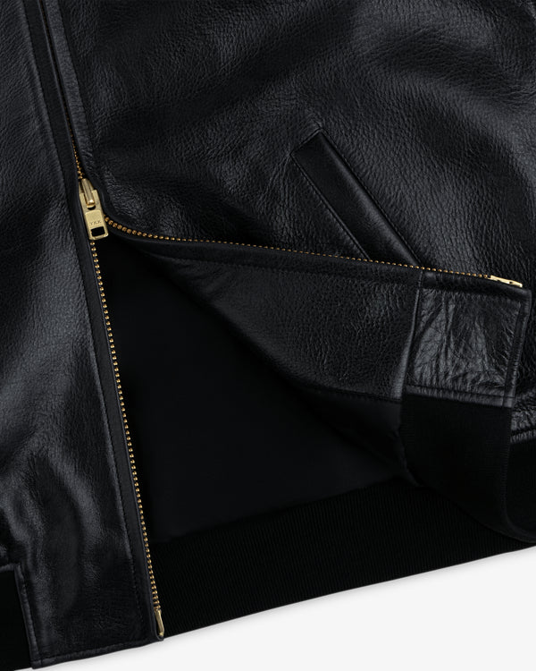 ALD / Technics Varsity Leather Jacket in black leather with gold zippers and a partially open front.