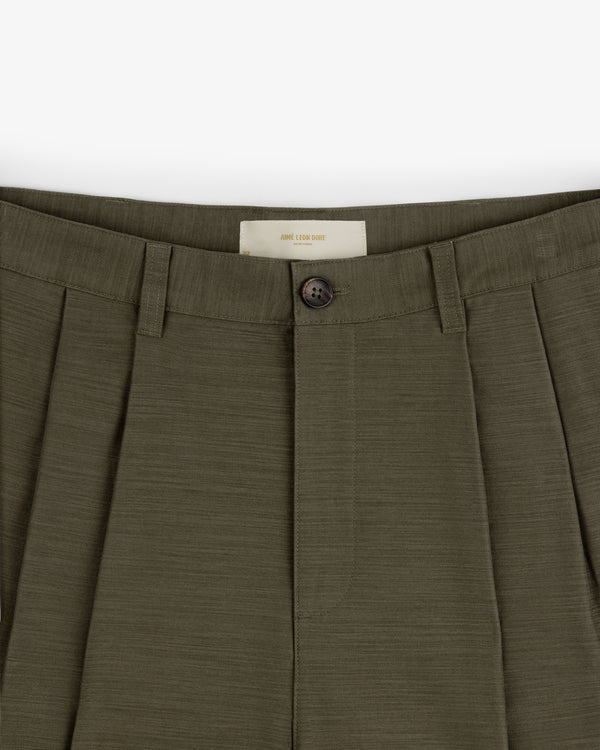 Close-up of Double Pleated Pant in olive green, featuring button closure and belt loops.