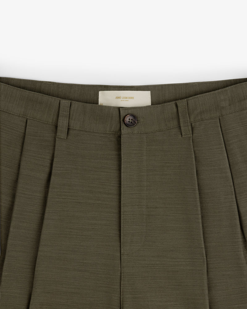Close-up of Double Pleated Pant in olive green, featuring button closure and belt loops.