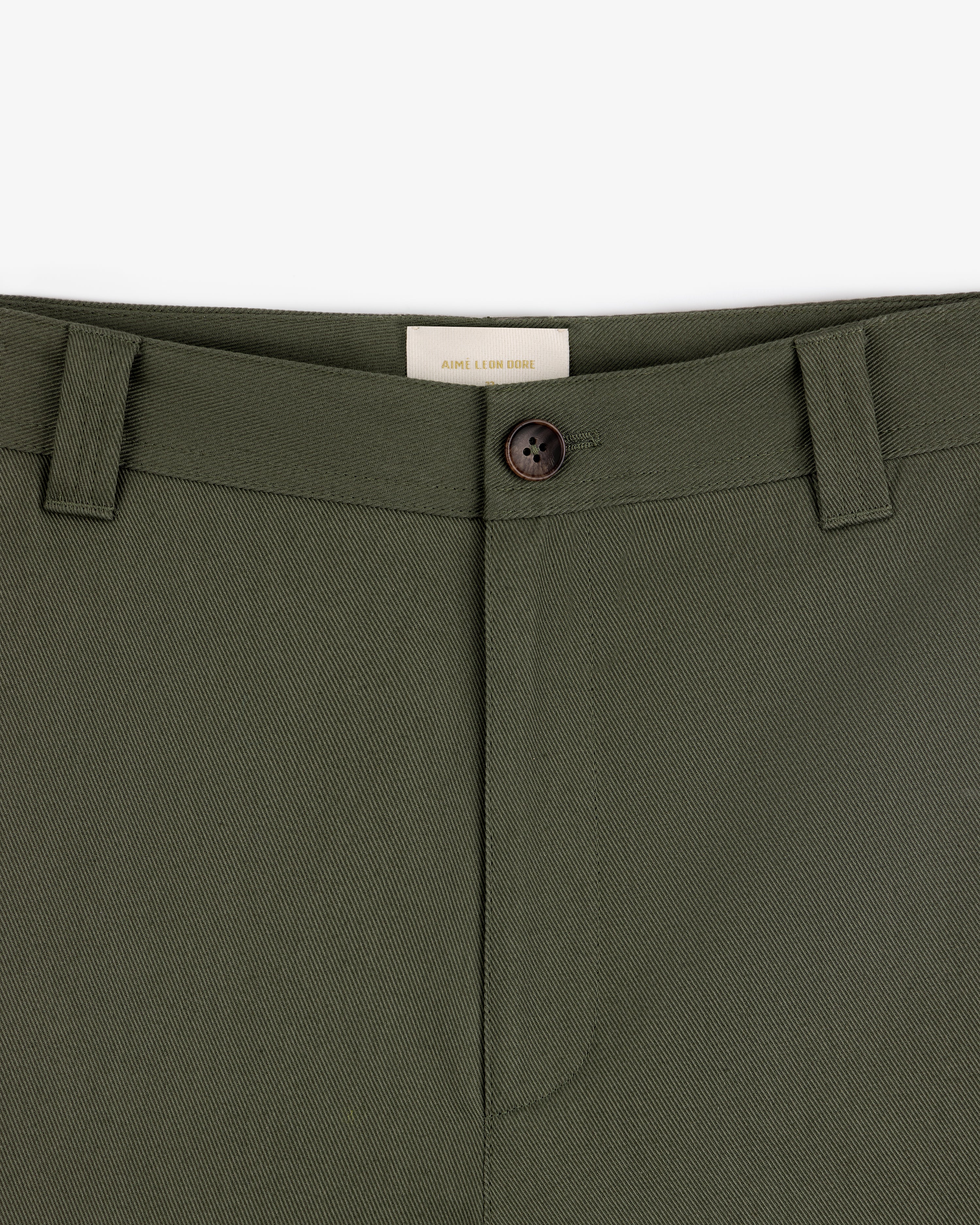 Close-up of Officer Pant in olive green with belt loops, button closure, and a visible waistband label on white background.