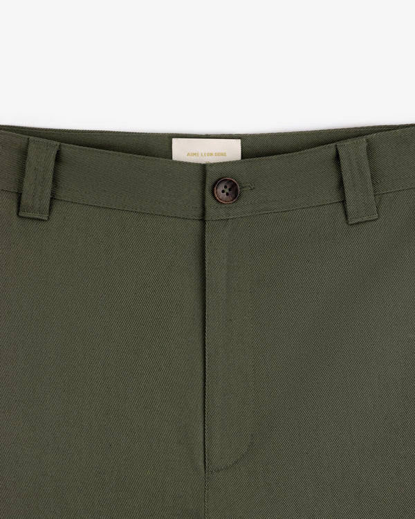 Close-up of Officer Pant in olive green with belt loops, button closure, and a visible waistband label on white background.