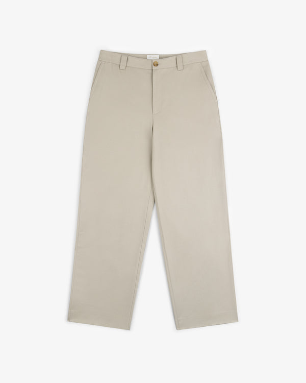 Officer Pant in beige, featuring straight legs, side pockets, belt loops, and button closure, shown on white.