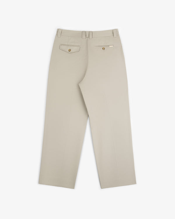 Officer Pant in beige shown from the back with two buttoned rear pockets and belt loops.