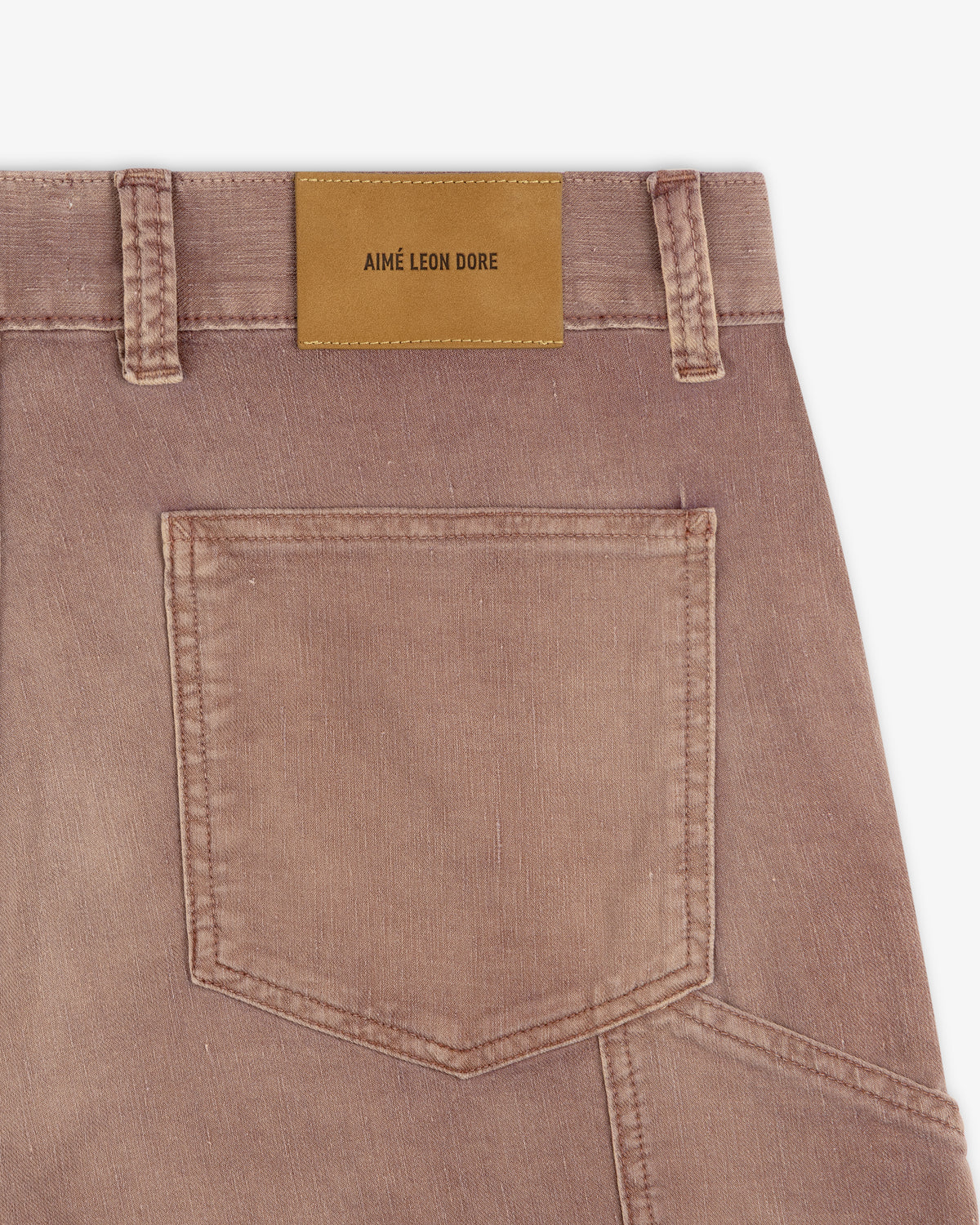 Close-up of Linen Blend Carpenter Pant’s brown back pocket with a tan leather "Aimé Leon Dore" label on the waistband.
