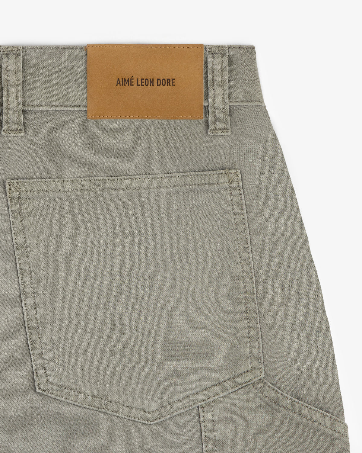 Close-up of Linen Blend Carpenter Pant featuring a large back pocket and a brown AIMÉ LEON DORE patch on the waistband.