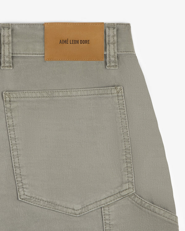 Close-up of Linen Blend Carpenter Pant featuring a large back pocket and a brown AIMÉ LEON DORE patch on the waistband.