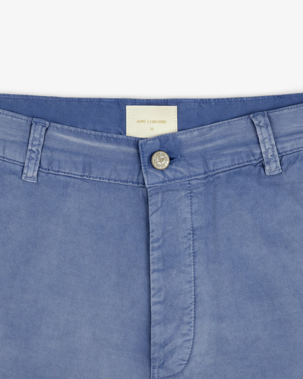 Close-up of Linen Blend Carpenter Pant waistband with belt loops, silver button, and white clothing label.