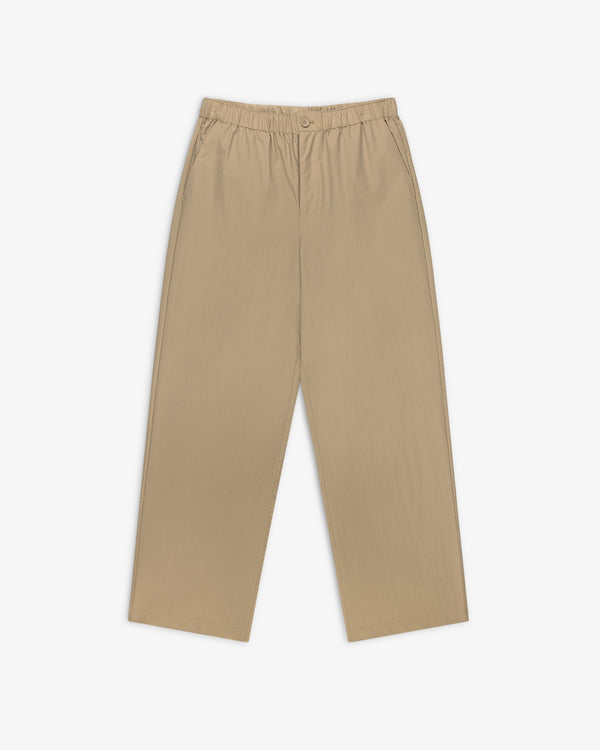 Relaxed Cotton Trouser in beige with straight legs, elastic waistband, button closure, and side pockets on white.