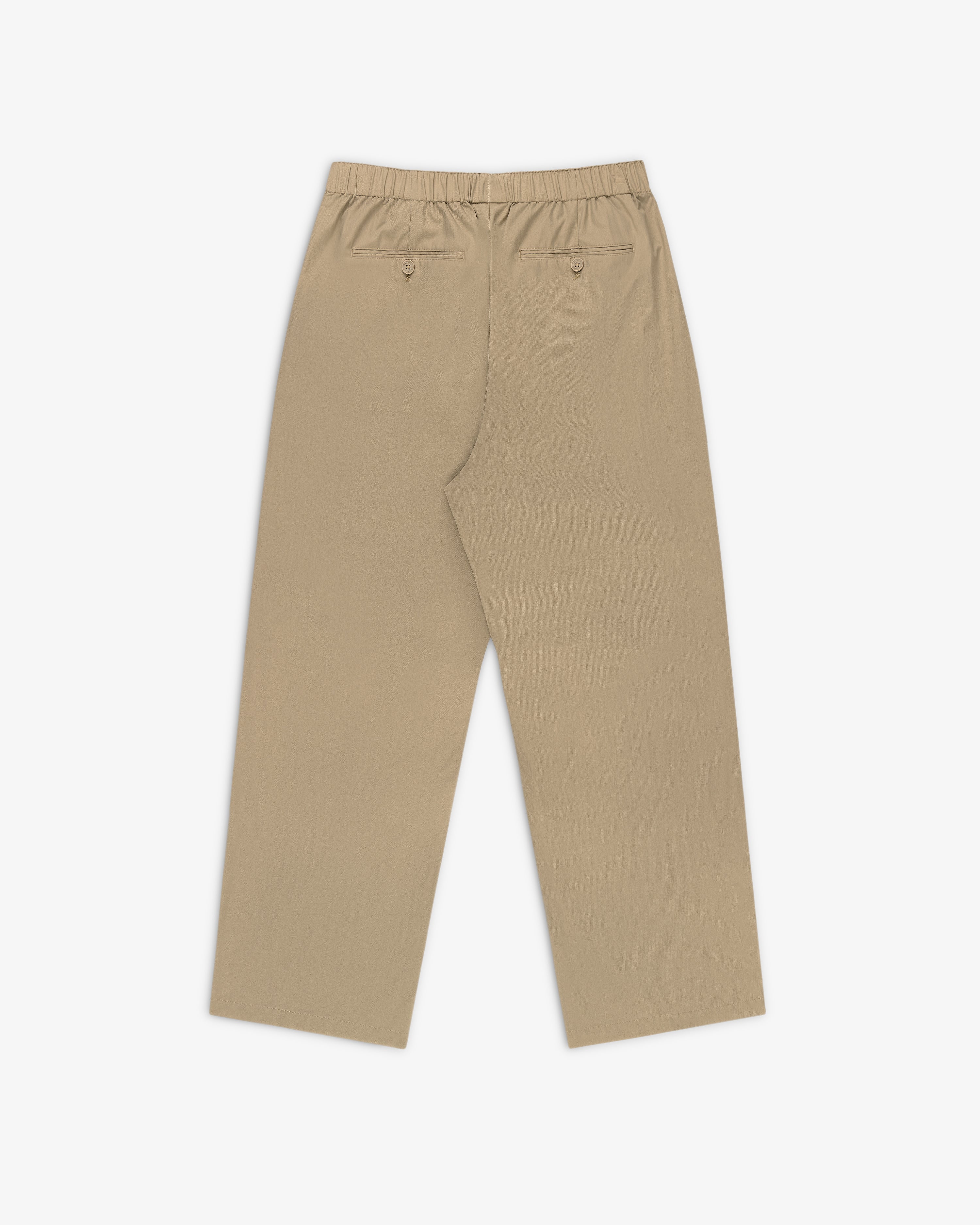 Relaxed Cotton Trouser in beige, wide-leg design with elastic waistband and two buttoned back pockets, laid flat.