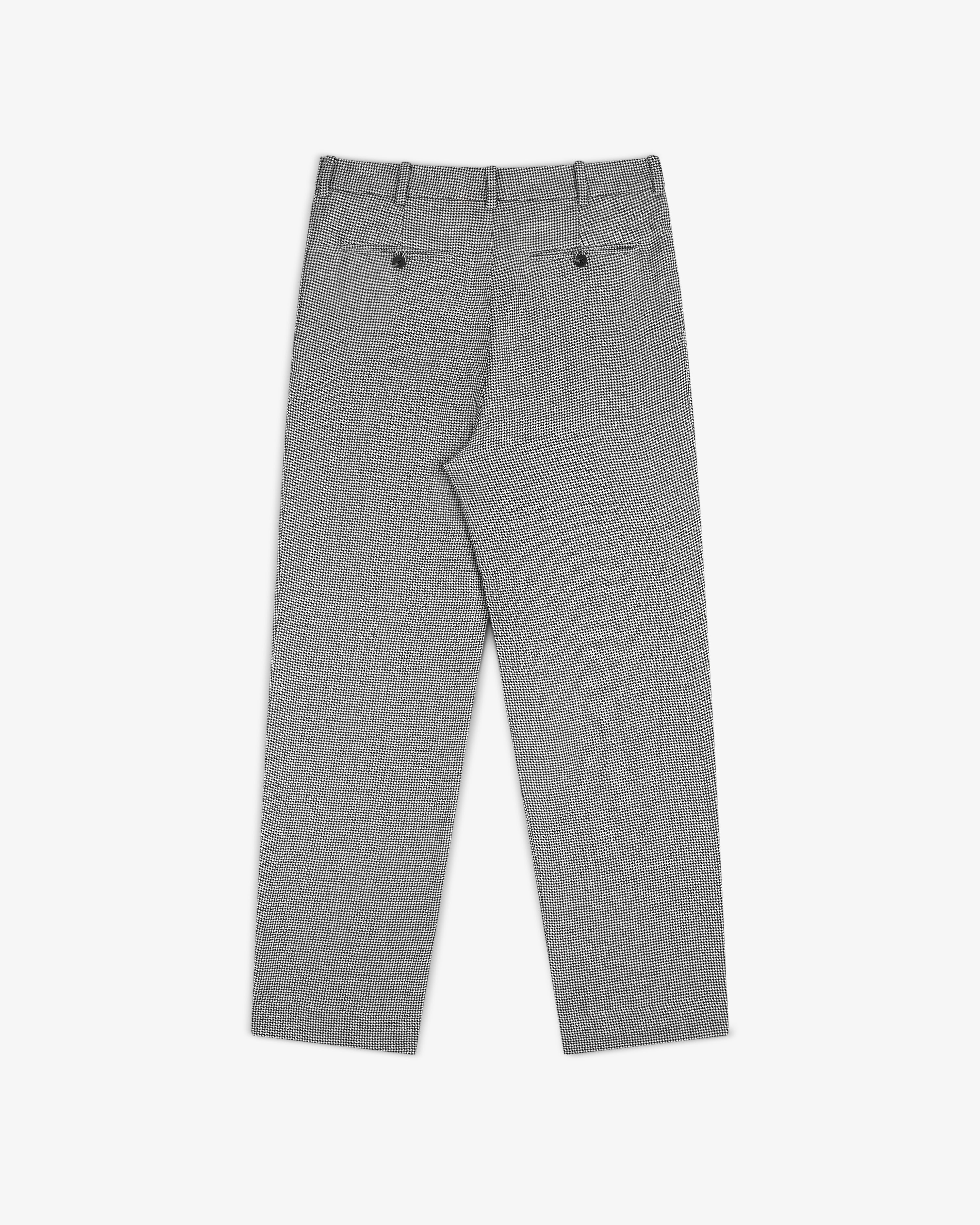 Houndstooth Pleated Trouser shown from the back with belt loops and two buttoned back pockets, laid flat on white.