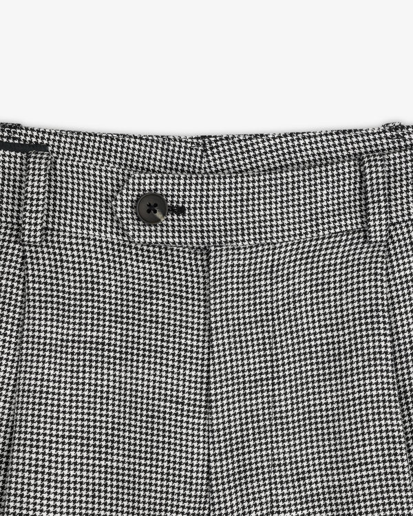 Close-up of the waistband on Houndstooth Pleated Trouser featuring a black button and belt loops.