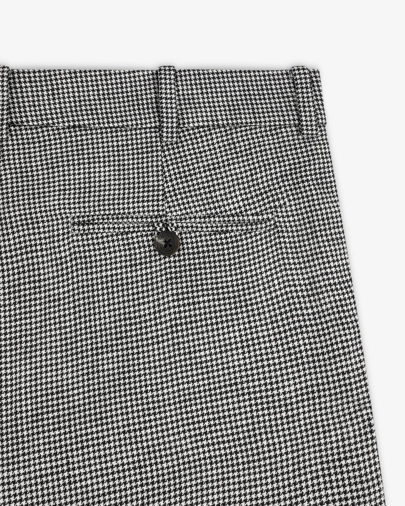 Close-up of Houndstooth Pleated Trouser in black and white, featuring a back pocket and black button.