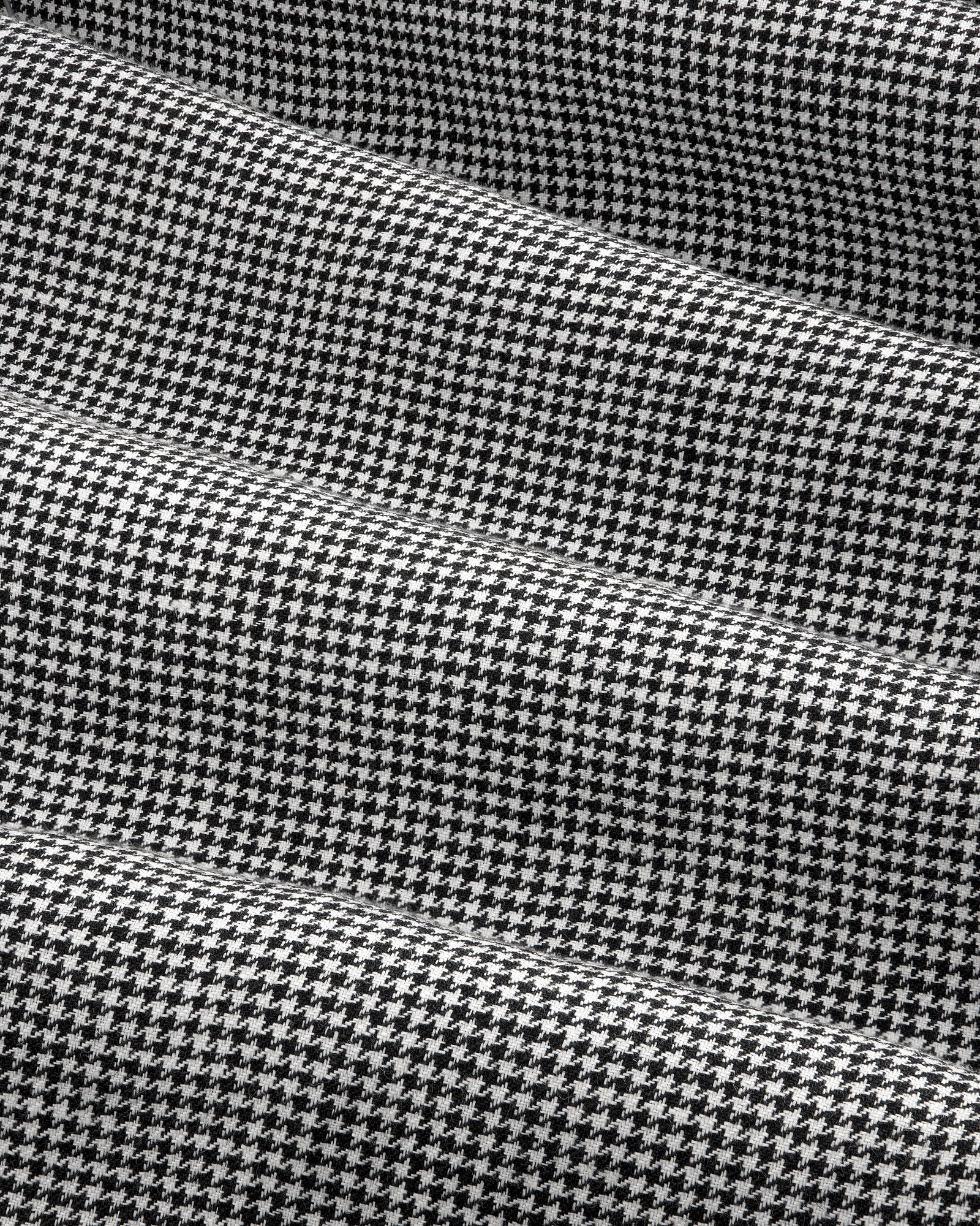 Black and white houndstooth Pleated Trouser with gentle folds and a soft, textured appearance.