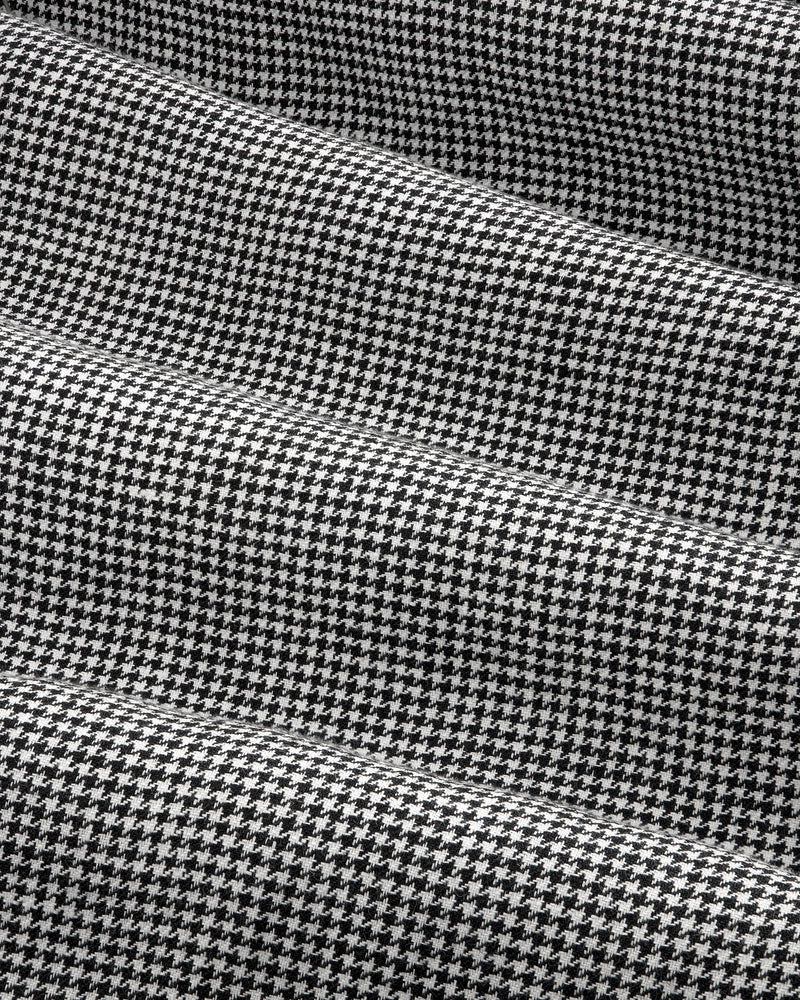 Black and white houndstooth Pleated Trouser with gentle folds and a soft, textured appearance.