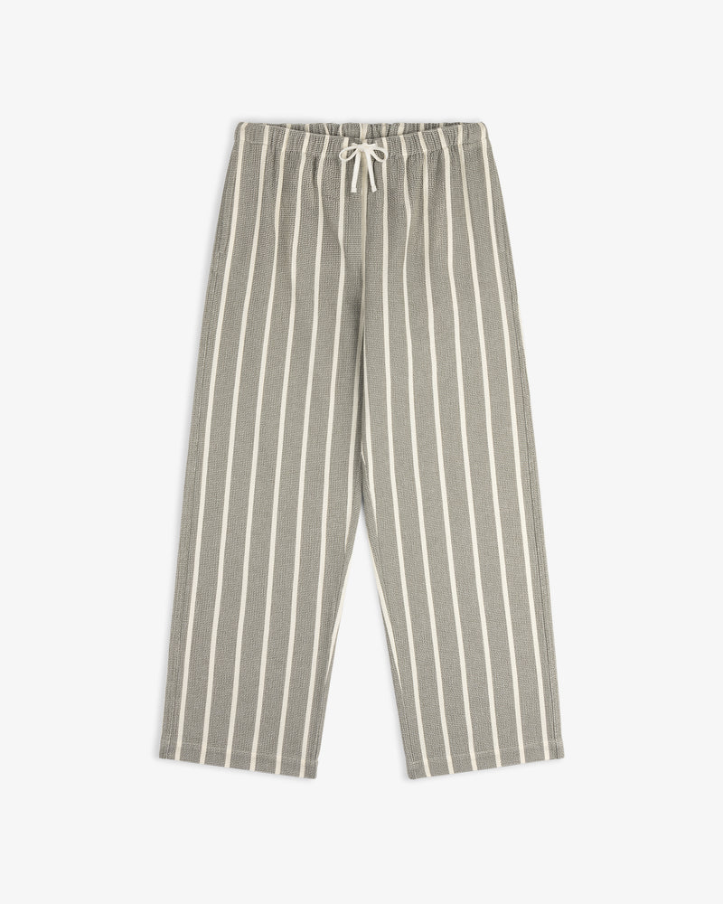 The Wide Leg Shore Pant features gray fabric with white stripes, an elastic drawstring waist, and wide legs.
