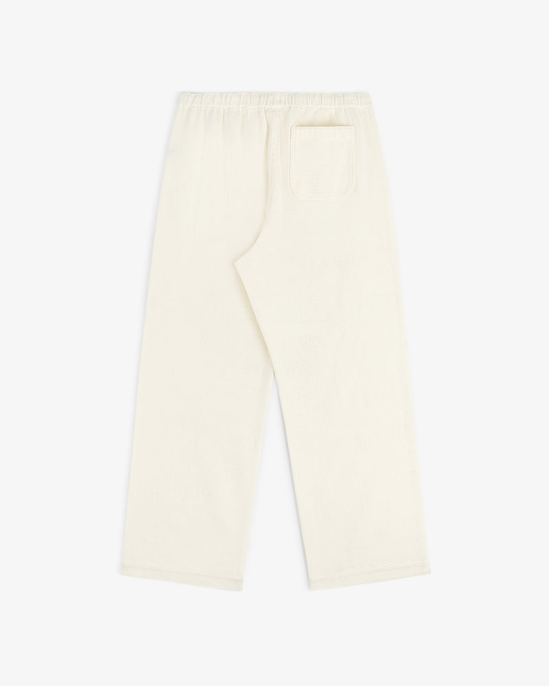 Cream-colored Wide Leg Shore Pant with an elastic waistband and back pocket, shown flat on a white background.