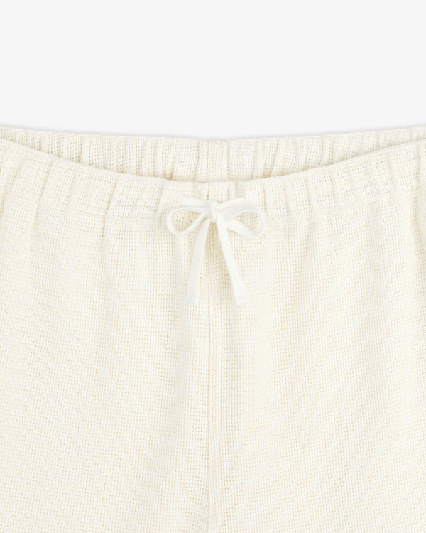 Close-up of Wide Leg Shore Pant in cream with elastic waistband and center-tied drawstring.