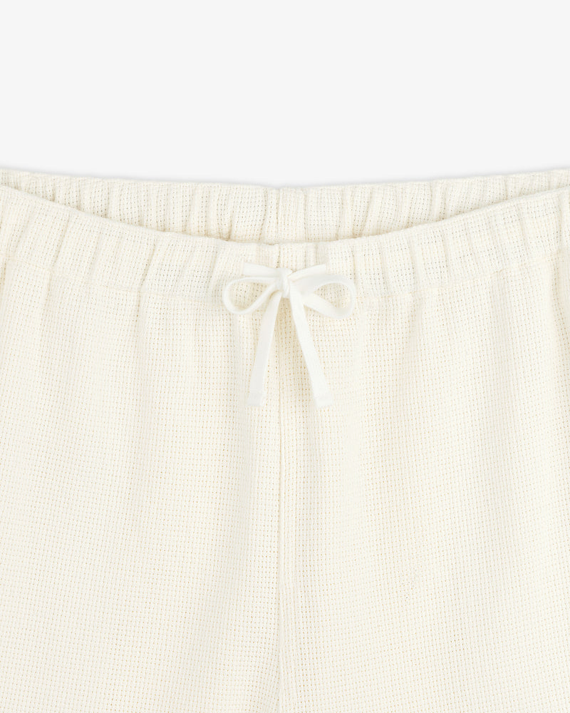 Close-up of Wide Leg Shore Pant in cream with elastic waistband and center-tied drawstring.