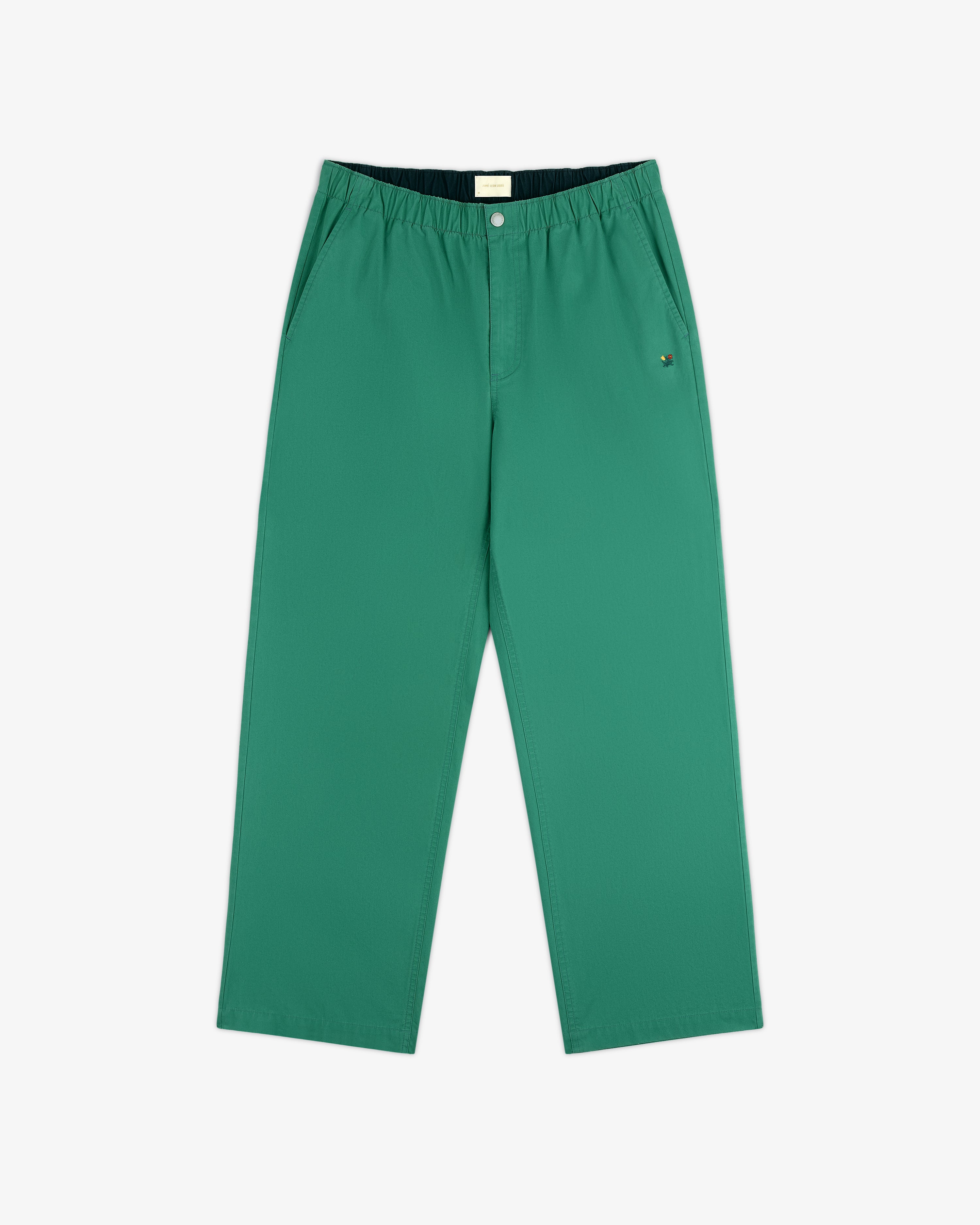 Washed Cotton Windbreaker Pant in green with elastic waistband, side pockets, and relaxed fit on white background.
