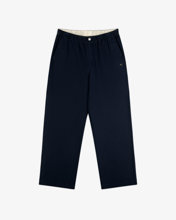 Washed Cotton Windbreaker Pant in navy blue features wide legs, elastic waistband, and small logo on left pocket.