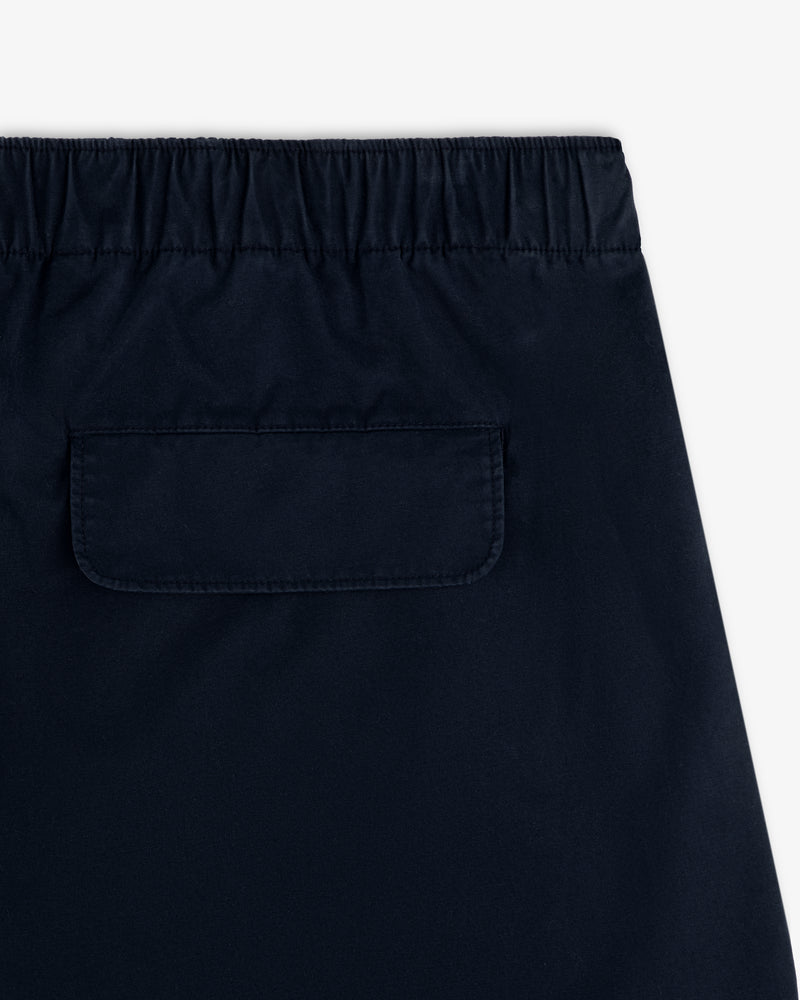 Close-up of the back of Washed Cotton Windbreaker Pant in navy with elastic waistband and flap pocket.
