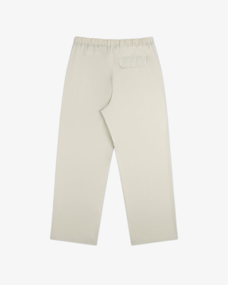 Washed Cotton Windbreaker Pant in beige, straight-leg with elastic waistband and single back pocket, shown flat.