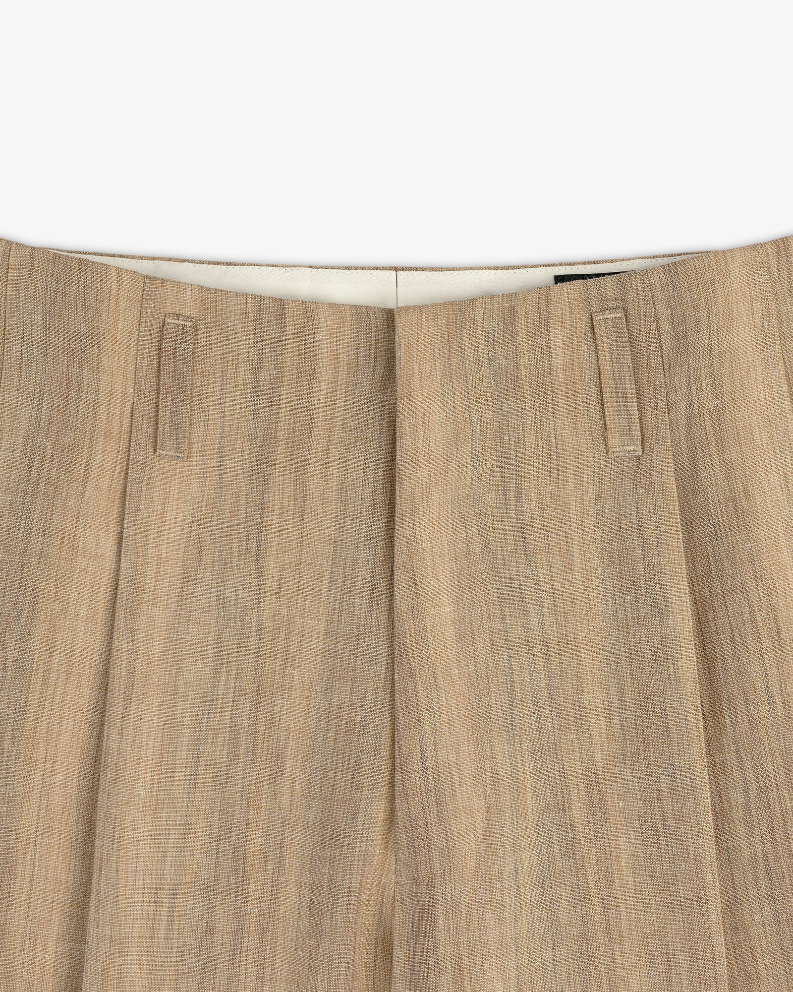 Close-up of the waistband and top of Double Pleated Safari Suit Trouser in light brown textured linen with belt loops.