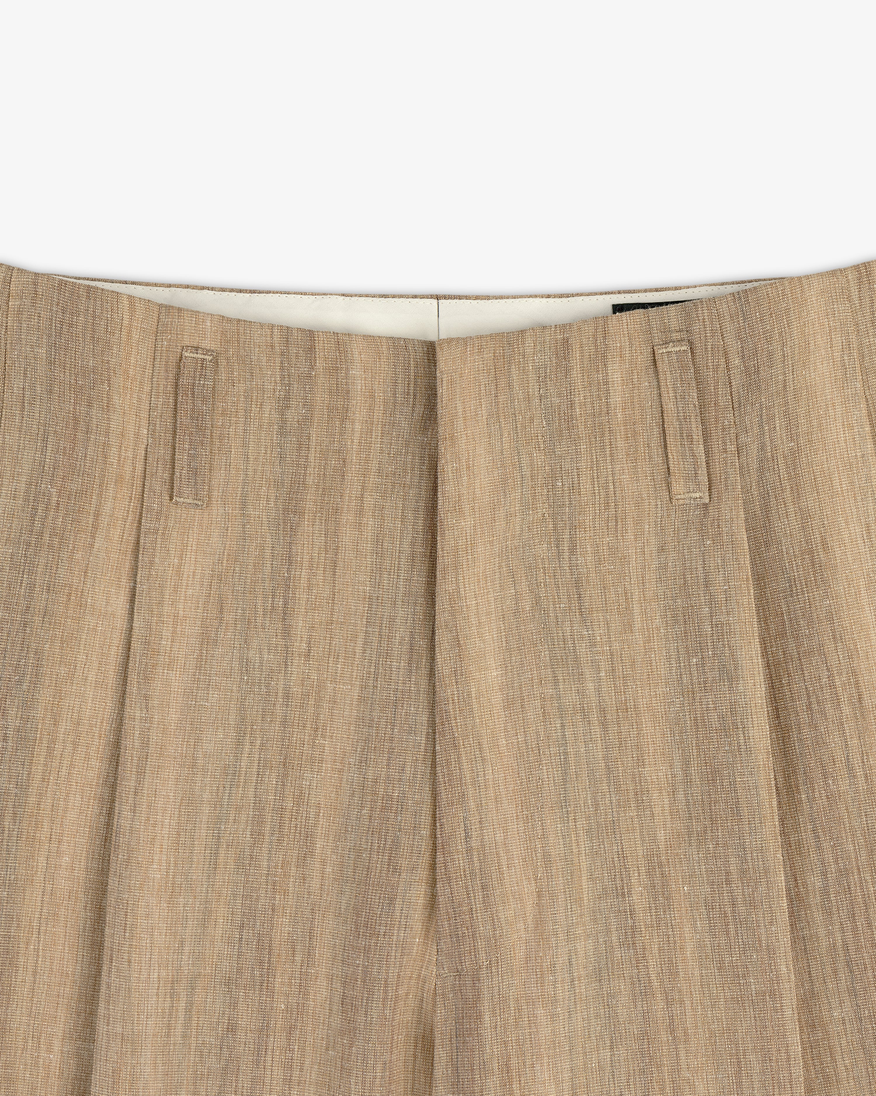 Close-up of the waistband and top of Double Pleated Safari Suit Trouser in light brown textured linen with belt loops.