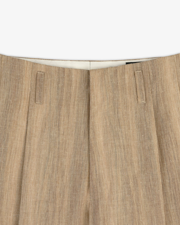 Close-up of the waistband and top of Double Pleated Safari Suit Trouser in light brown textured linen with belt loops.