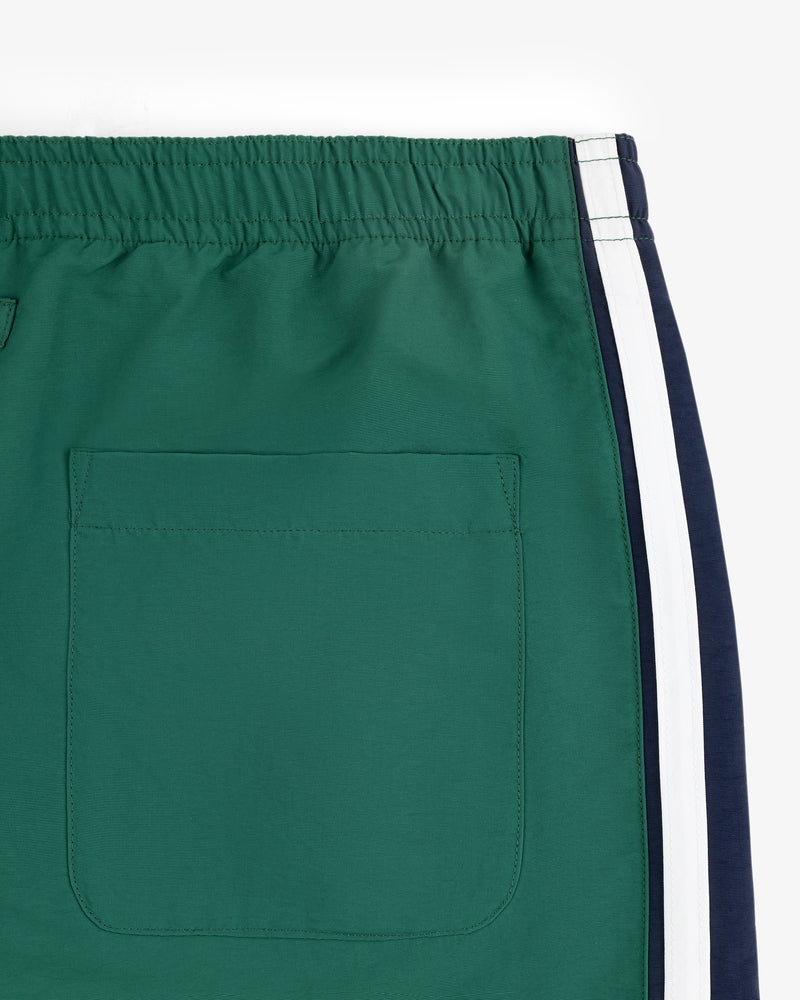 Colorblock Track Pant with elastic waistband, back pocket, and white/navy side stripes, on a white background.