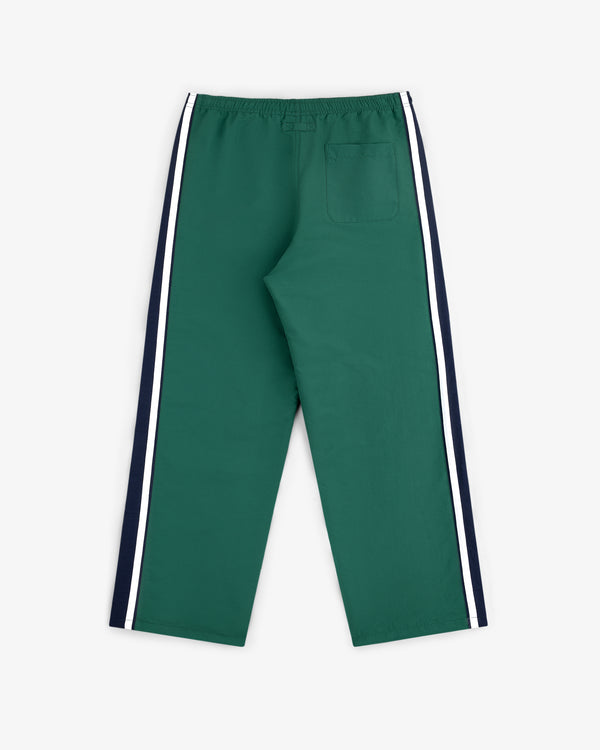 Colorblock Track Pant in green with white/navy side stripes, elastic waist, and single back pocket, shown flat on white.