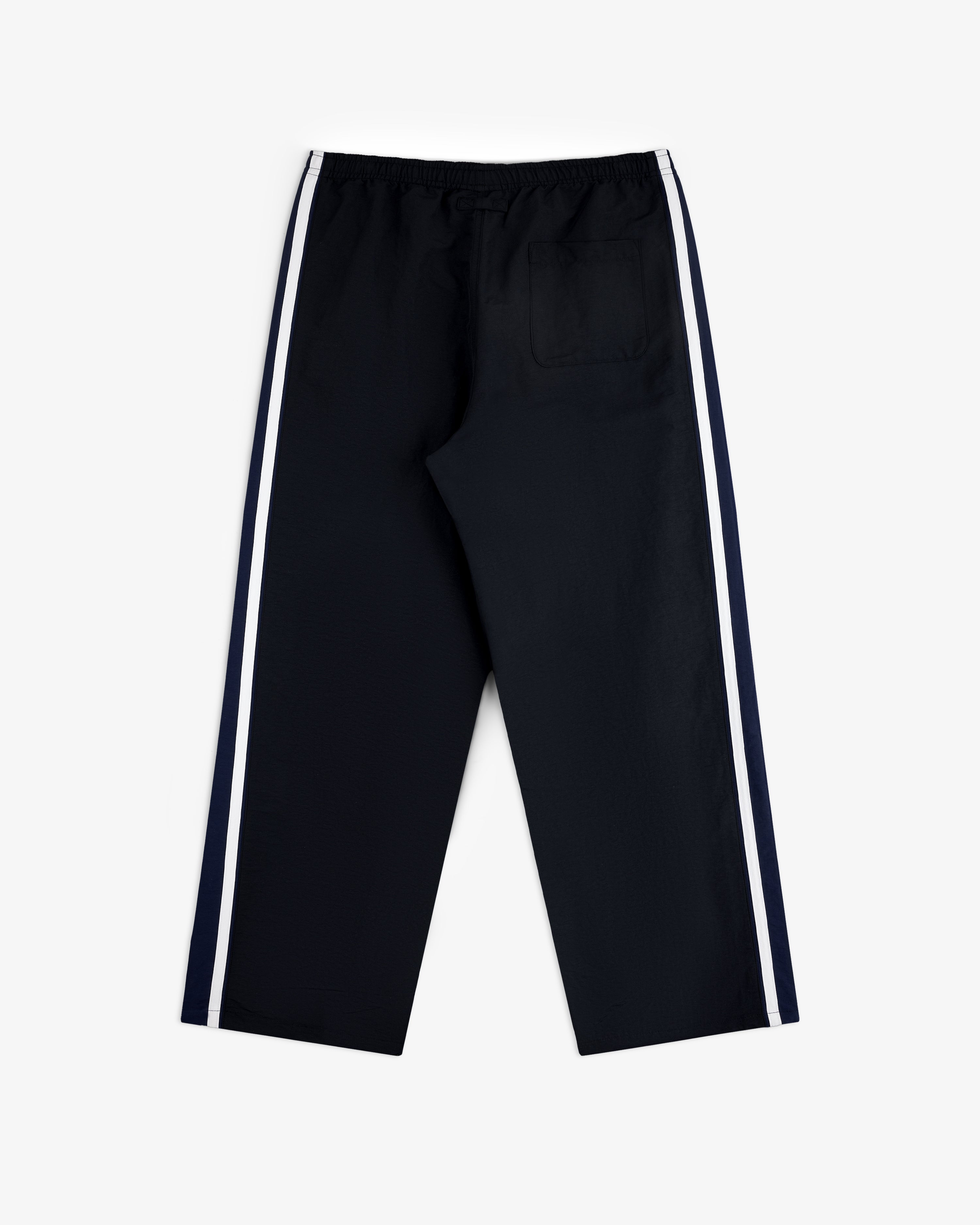 Colorblock Track Pant with white side stripes and single back pocket, flat on a white background.