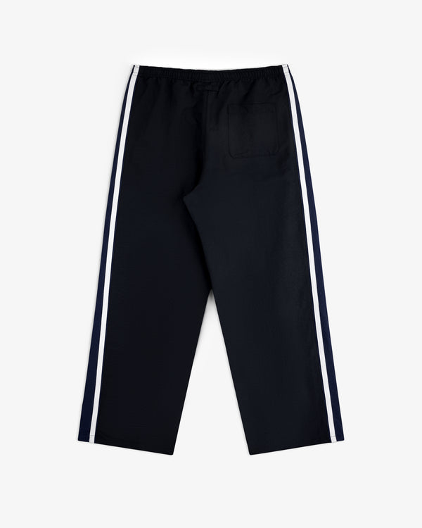 Colorblock Track Pant with white side stripes and single back pocket, flat on a white background.