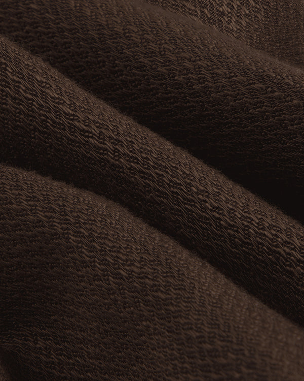 Close-up of folded Linen Blend Suit Trouser in dark brown, highlighting its textured weave.