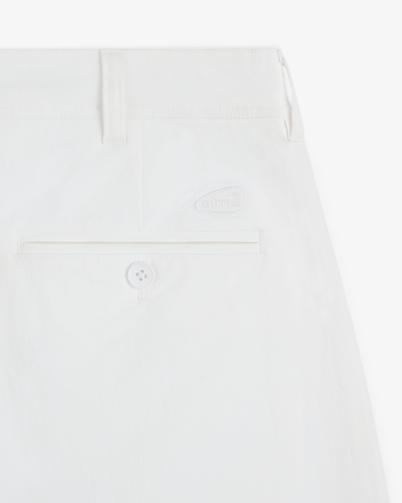 Close-up of the back pocket and waistband of ALD Golf Cordura Double Pleated Pant featuring a button and subtle logo.