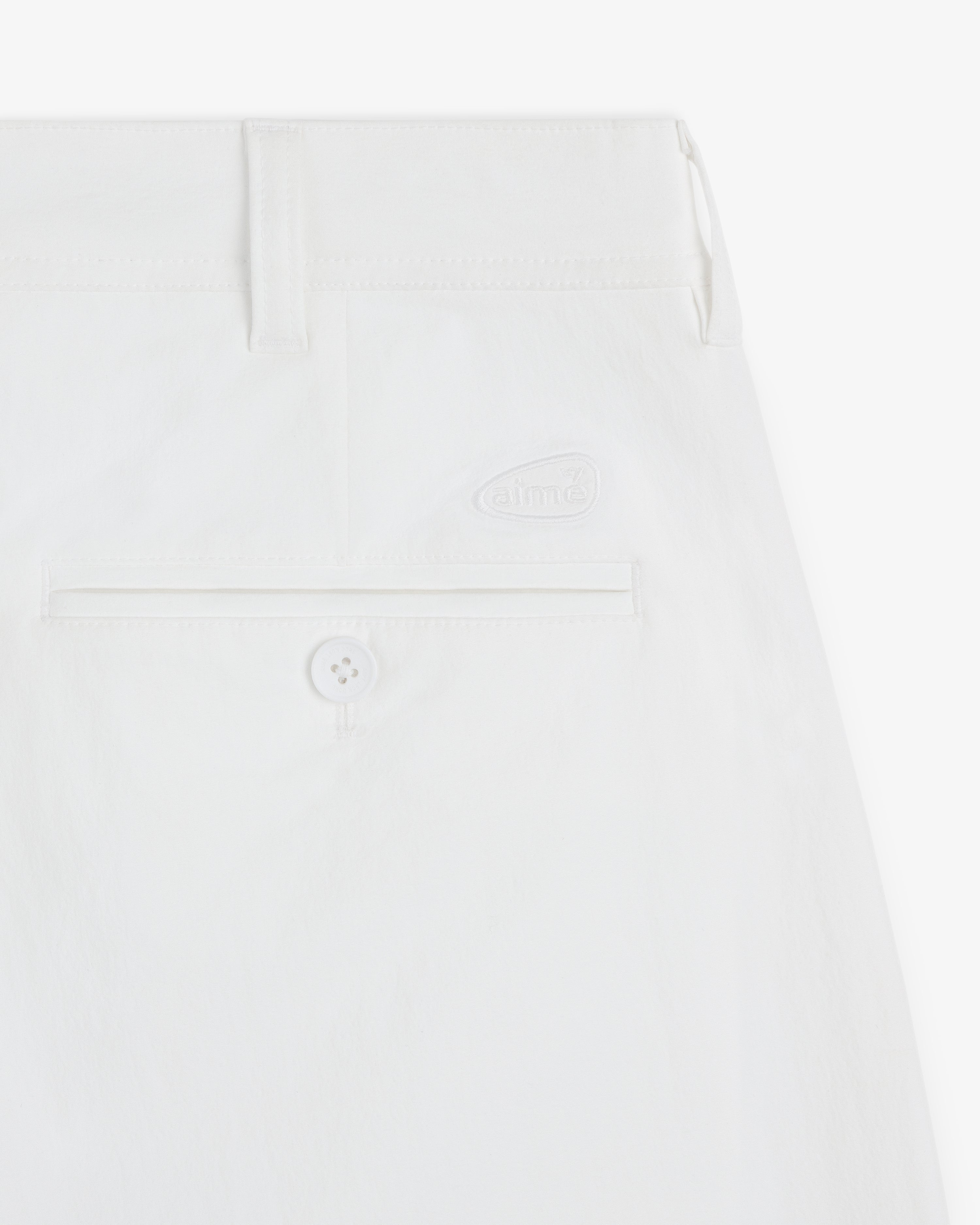 Close-up of the back pocket and waistband of ALD Golf Cordura Double Pleated Pant featuring a button and subtle logo.