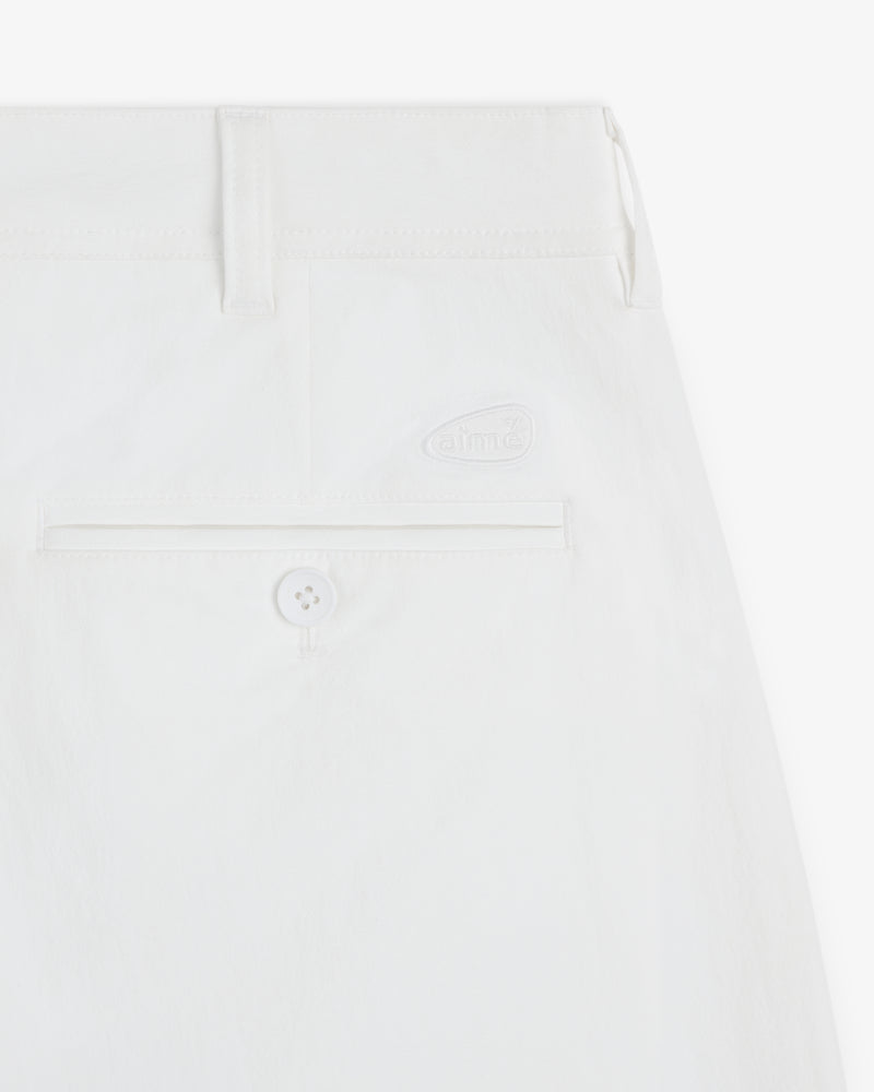 Close-up of the back pocket and waistband of ALD Golf Cordura Double Pleated Pant featuring a button and subtle logo.