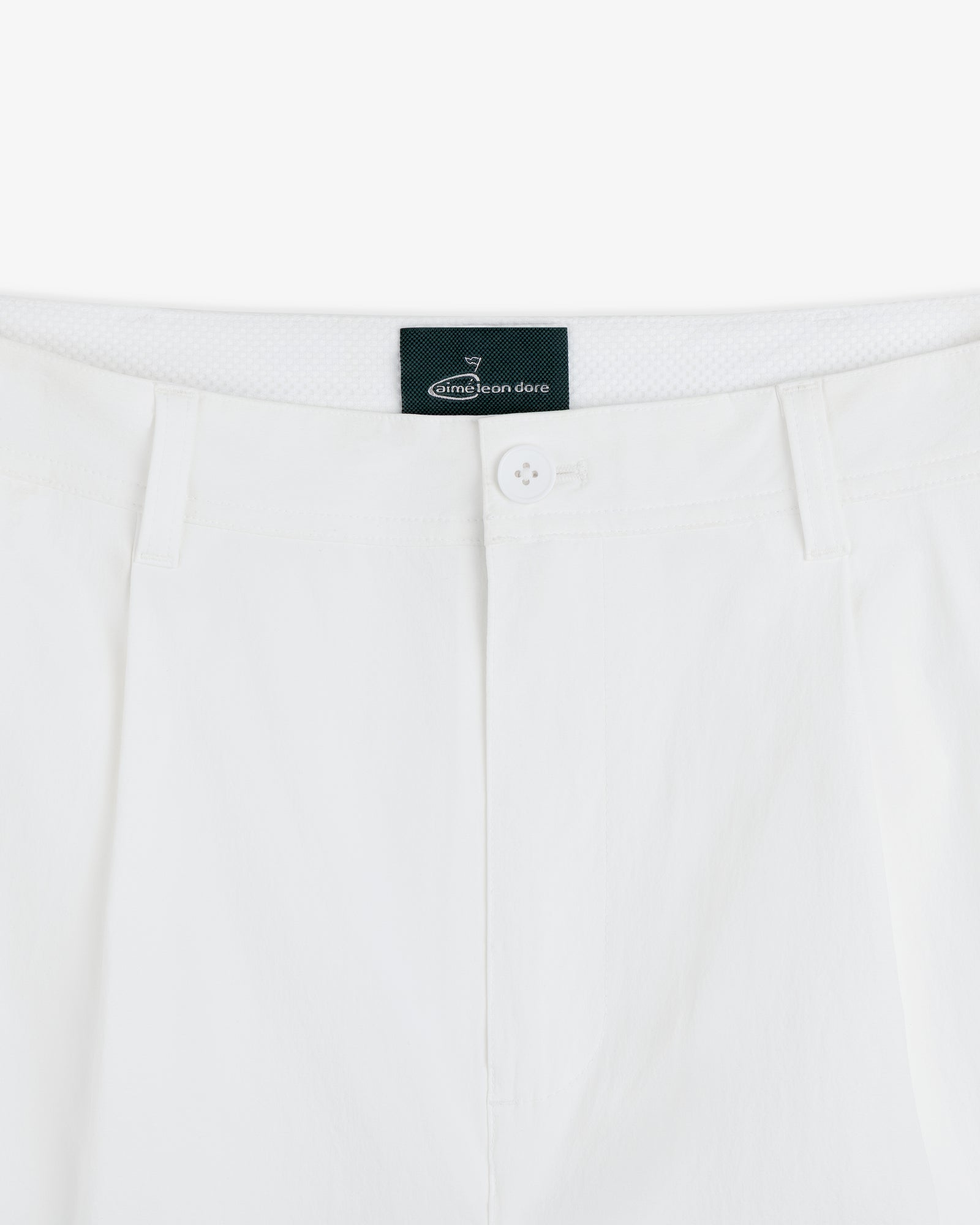 Close-up of the waistband and button of white ALD Golf Cordura Double Pleated Pant with belt loops and brand label.
