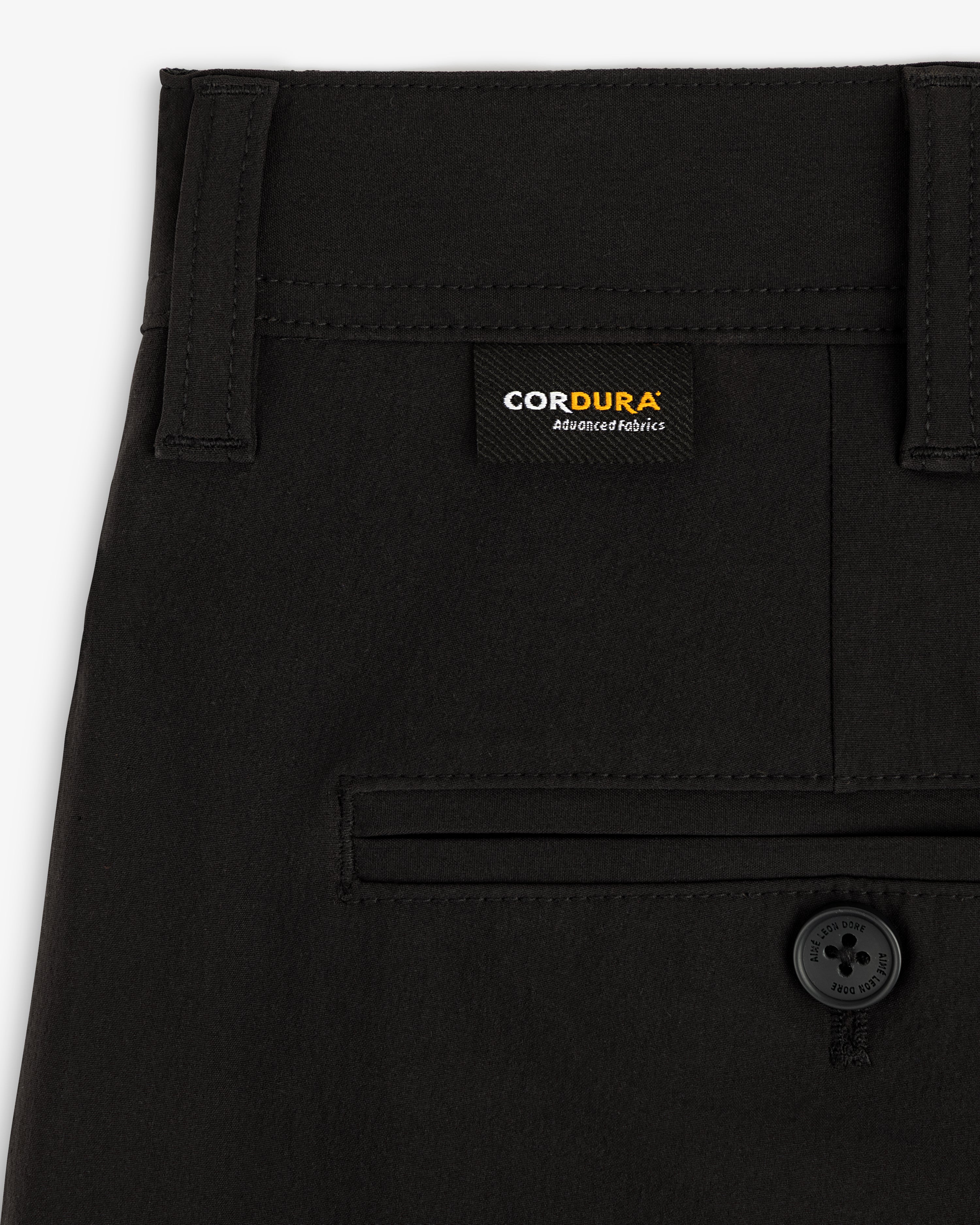Close-up of ALD Golf Cordura Double Pleated Pant with a buttoned back pocket and Cordura label above it.
