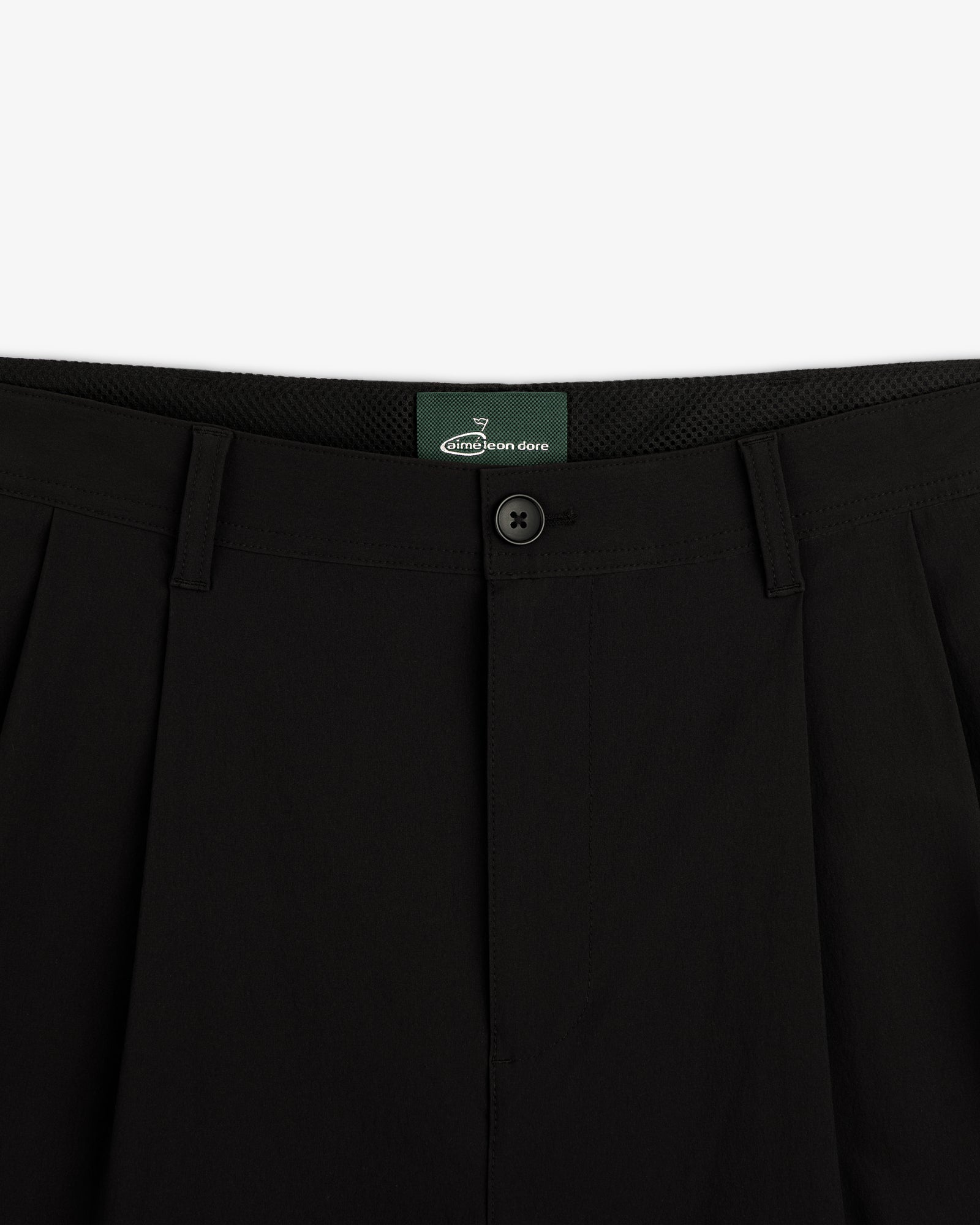 Close-up of the waistband and button on ALD Golf Cordura Double Pleated Pant in black, shown against a white background.
