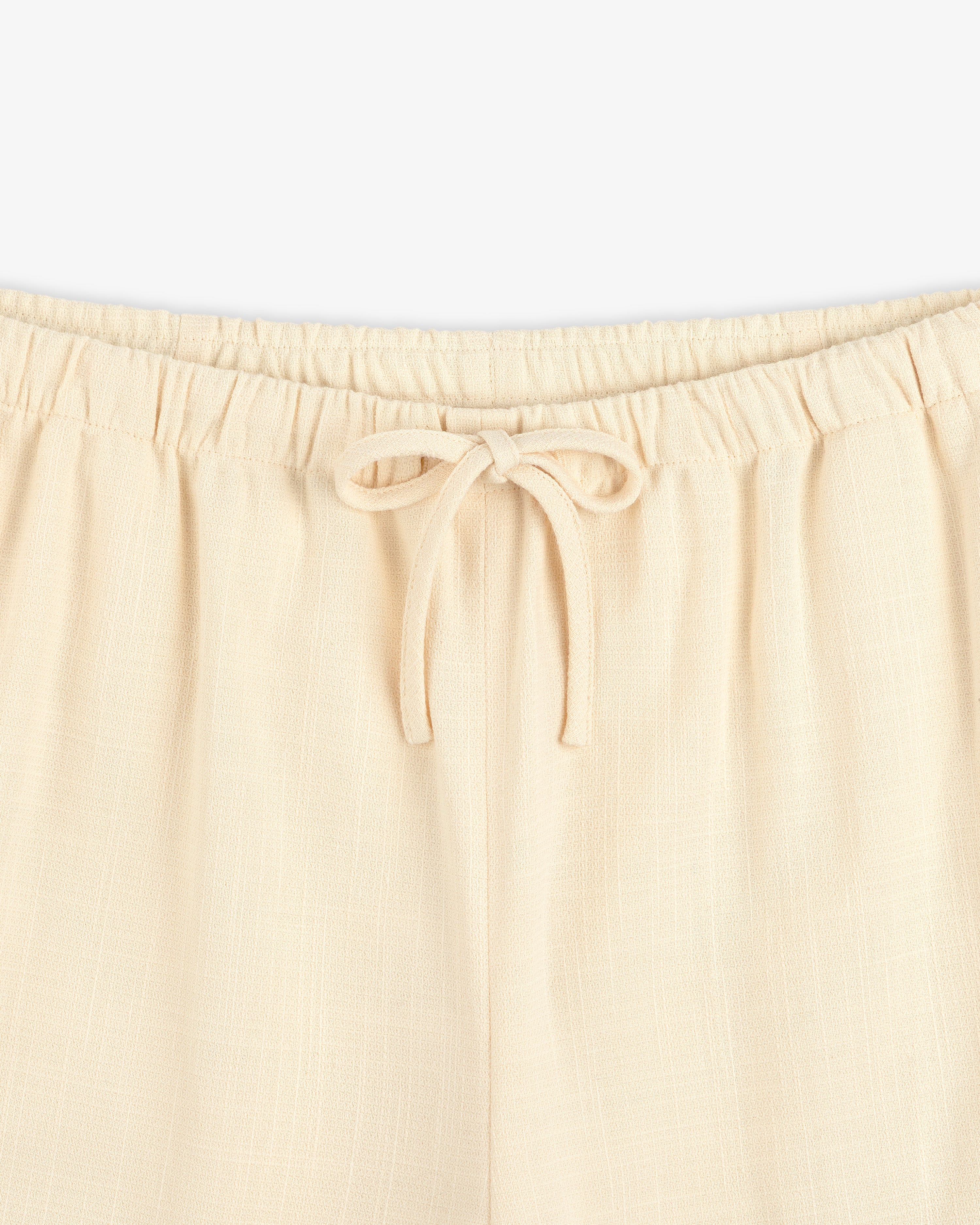 Drawstring Cotton Blend Suit Trouser in beige, featuring an elastic waistband; waist to upper thigh shown on white background.