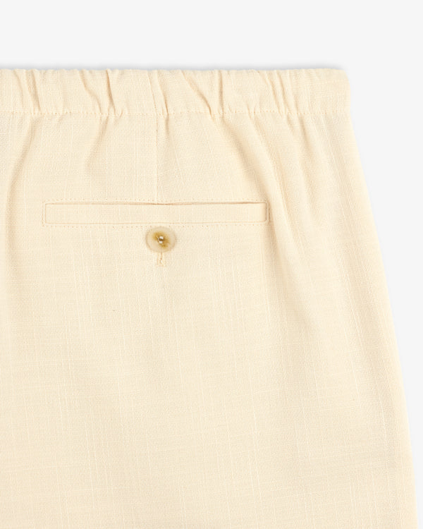 Close-up of Drawstring Cotton Blend Suit Trouser in beige, featuring an elastic waistband and a buttoned back pocket.