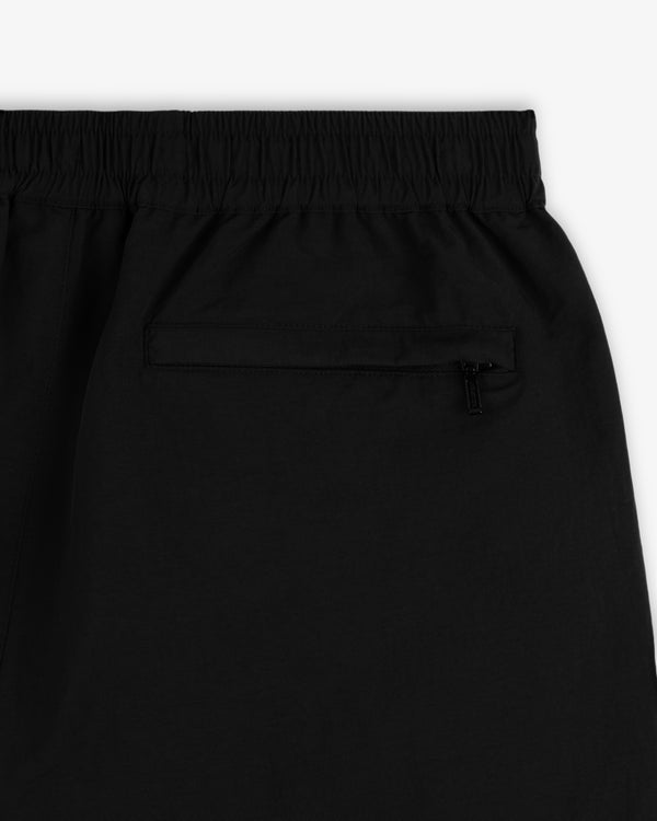 Close-up of Crest Nylon Track Pant in black with an elastic waistband and a zippered back pocket.