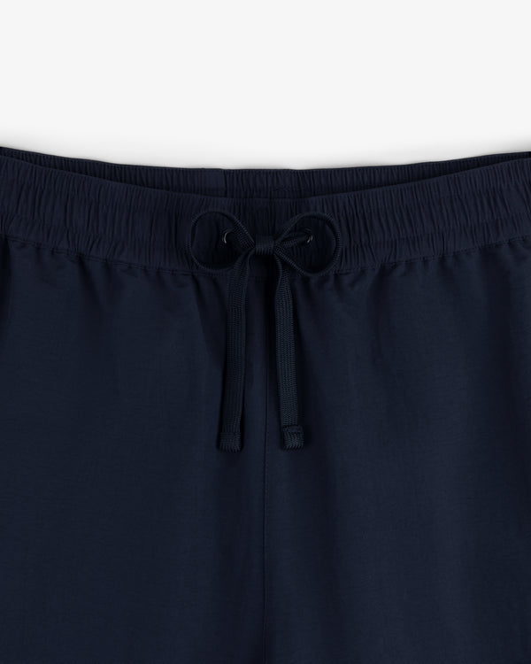 Close-up of Crest Nylon Track Pant in navy blue with an elastic waistband and drawstring, shown against a plain background.