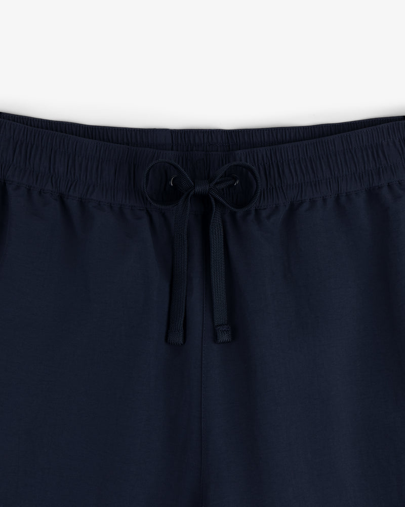 Close-up of Crest Nylon Track Pant in navy blue with an elastic waistband and drawstring, shown against a plain background.