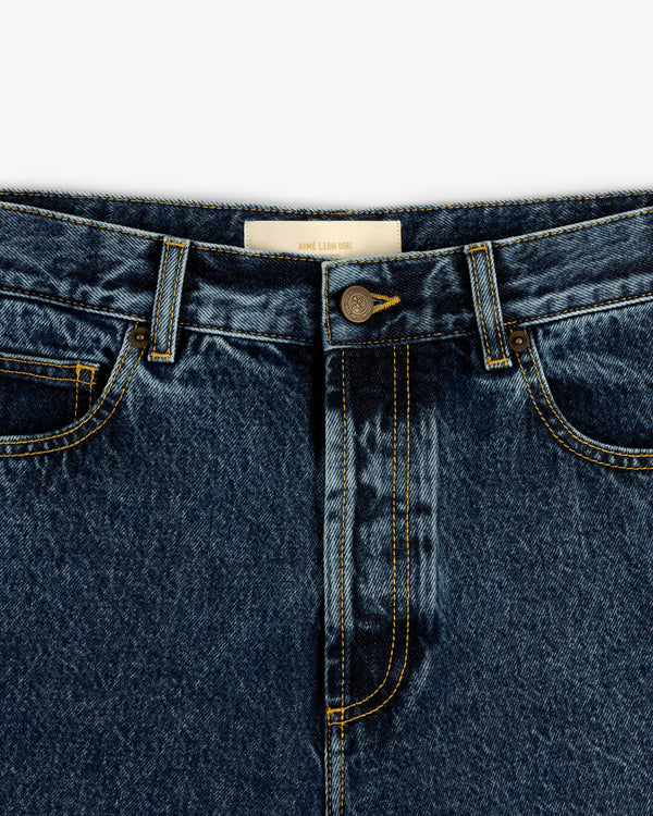 Close-up of Relaxed Fit 5-Pocket Denim Pant in blue with button closure, front pockets, and yellow stitching.